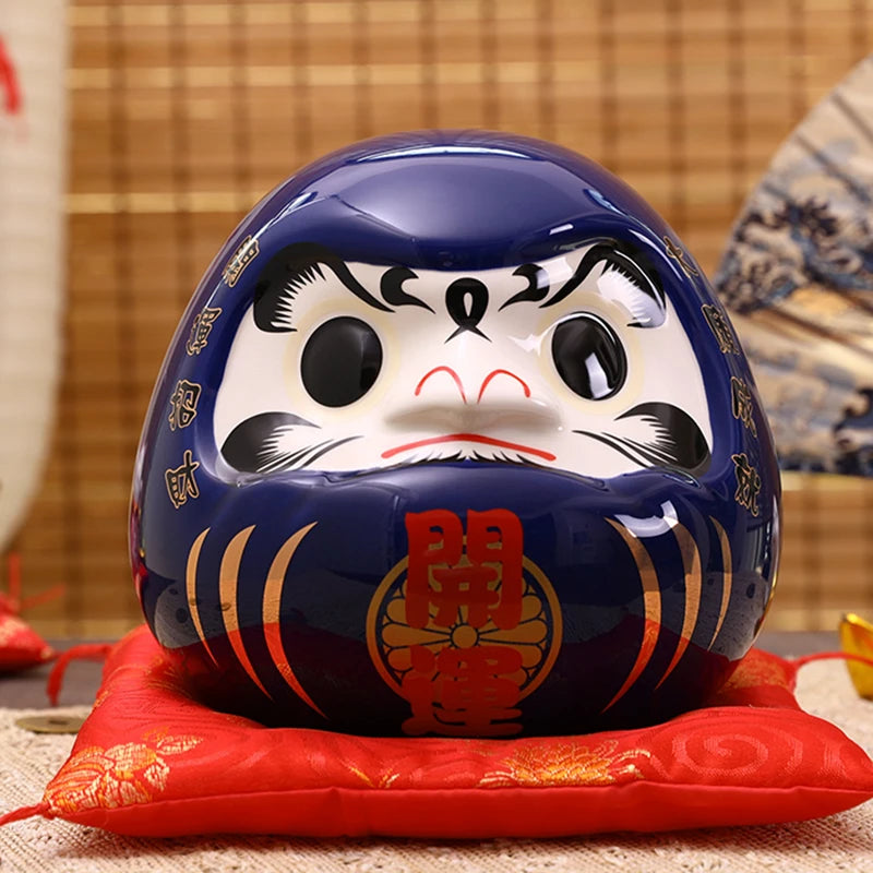 Tirelire Daruma bleue japonaise en céramique brillante pour le succès des études et de la carrière.