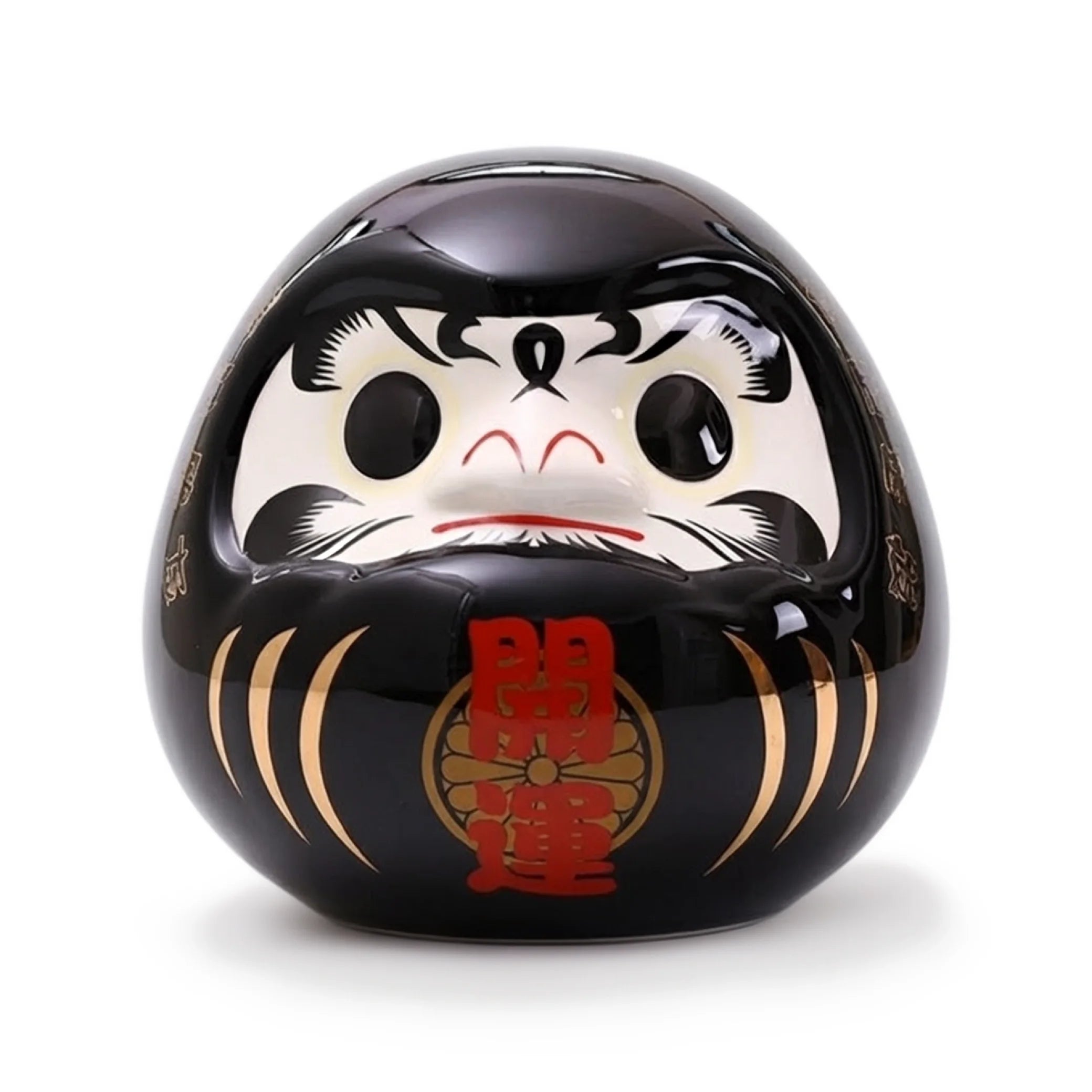 Tirelire Daruma noire en céramique brillante, symbole de protection et de succès professionnel japonais.